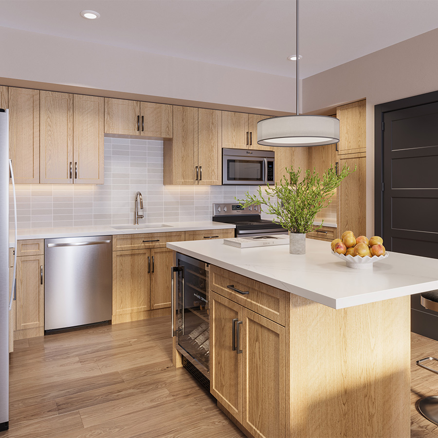 Kitchen with wood style floor and cabinets, light counters, and stainless steel appliances at Elysium Apartments.